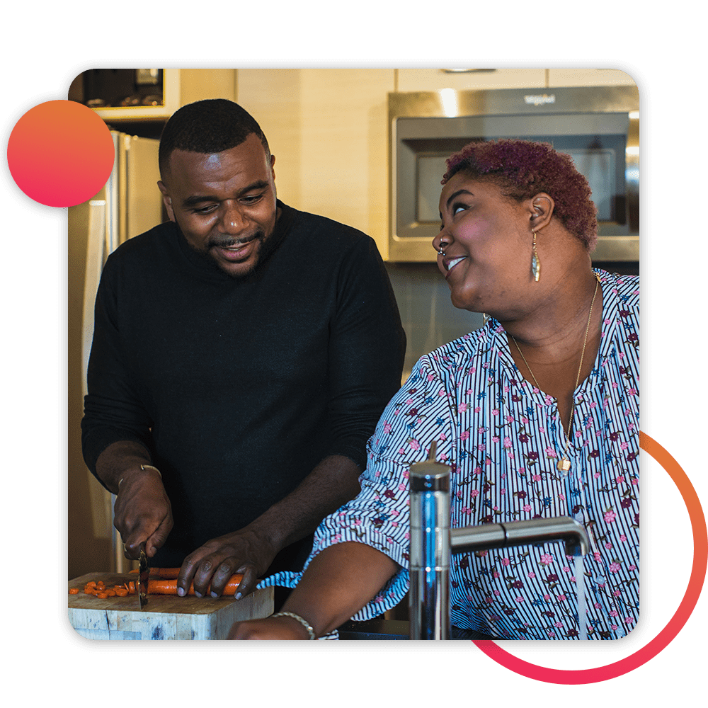 couple preparing food together in kitchen