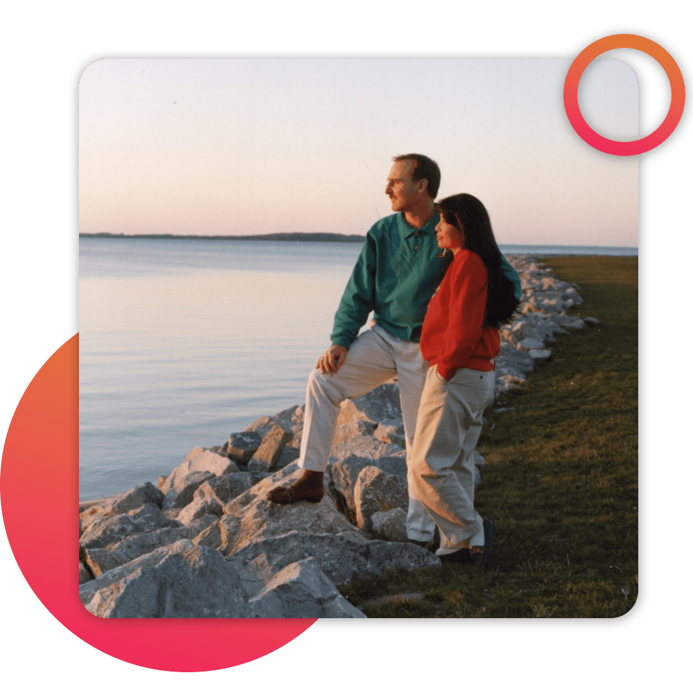 couple on beach watching sunrise/set