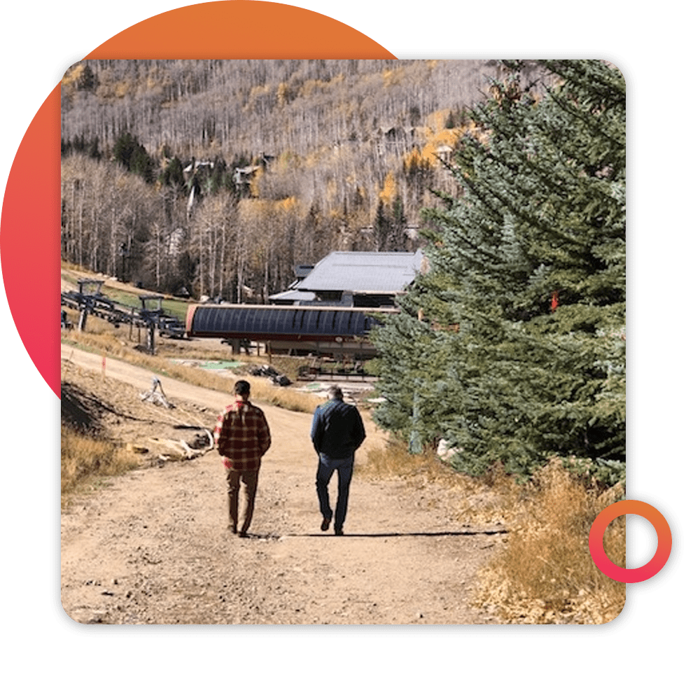 two people walking on rural road