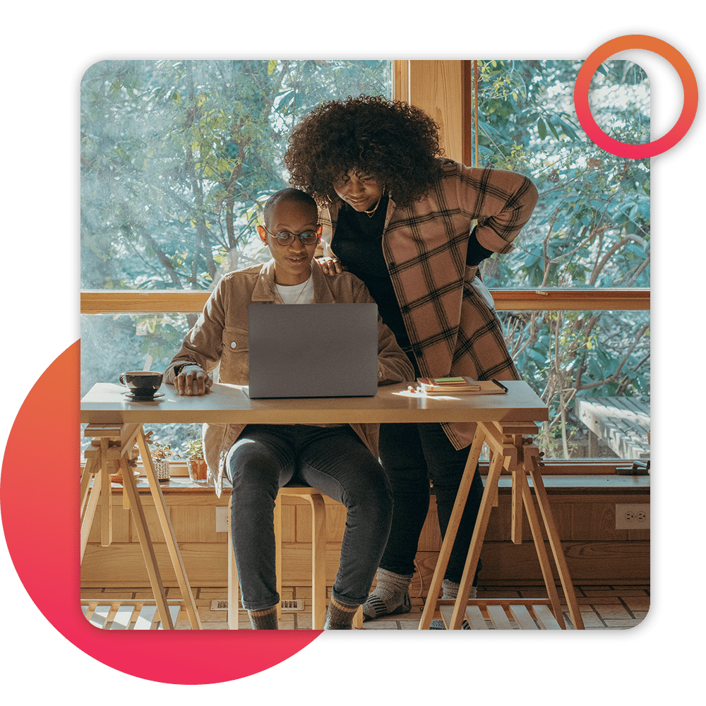 couple looking at computer at kitchen table