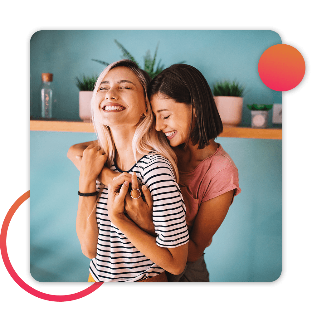 two women embracing each other in kitchen