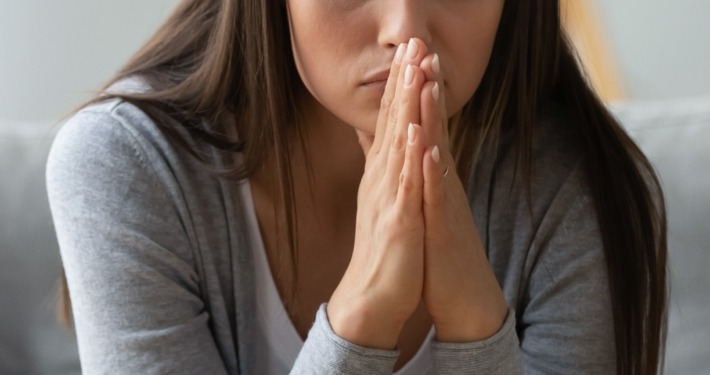 Pensive millennial girl sit on sofa in living room look in distance thinking or pondering of problem, thoughtful young woman lost in thoughts feel frustrated or distressed at home, drama concept